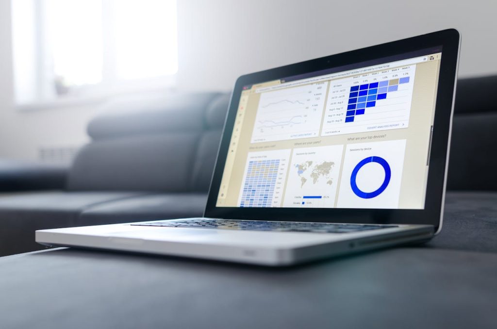 pexels-photo-577210 Sleek laptop showcasing data analytics and graphs on the screen in a bright room.